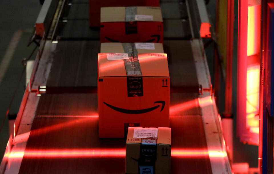 FILE - In this Aug. 1, 2017, file photo, packages riding on a belt are scanned to be loaded onto delivery trucks at the Amazon Fulfillment center in Robbinsville Township, N.J. Amazon, Walmart and others are promising to deliver more of their goods in a day and this holiday season will be the first real test of whether they can make that happen. (AP Photo/Julio Cortez, File)