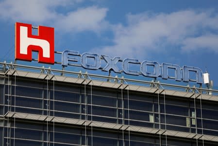 FILE PHOTO: The logo of Foxconn, the trading name of Hon Hai Precision Industry, is seen on top of the company's building in Taipei