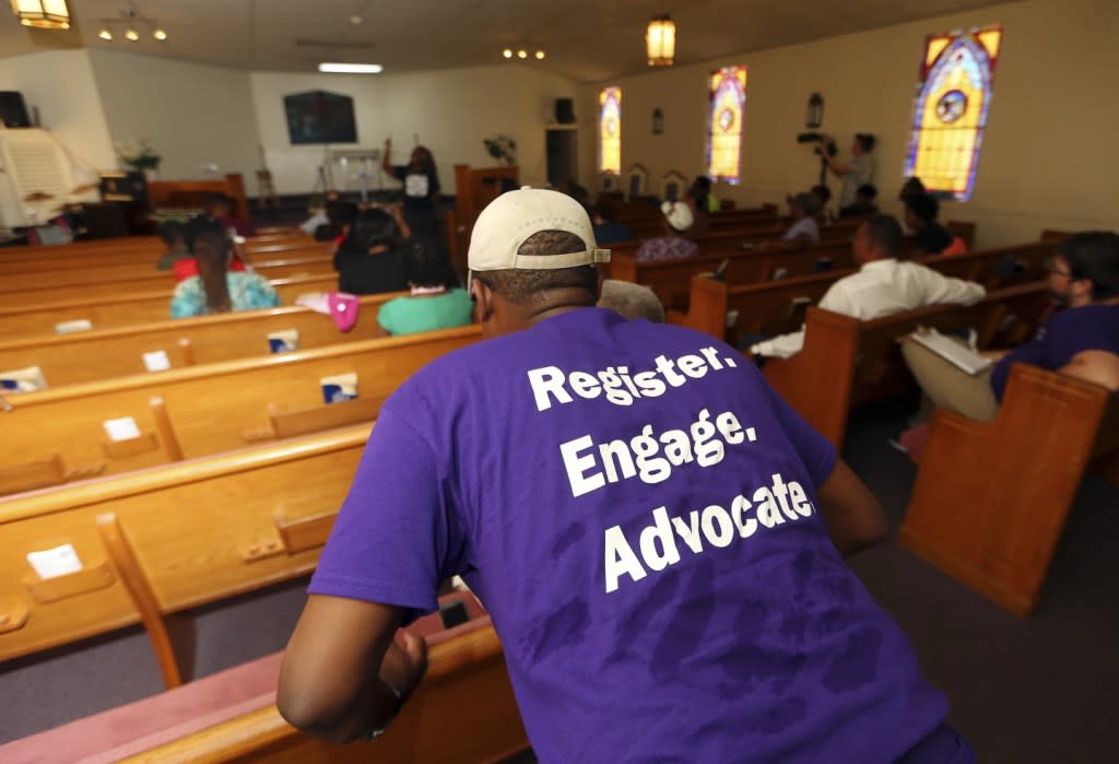 A man listens as Black Voters Matter co-founder LaTosha Brown speaks at a church as part of The South Rising Tour 2018 on Aug. 22, 2018, in Warner Robins, Ga. (AP Photo/John Bazemore, File)