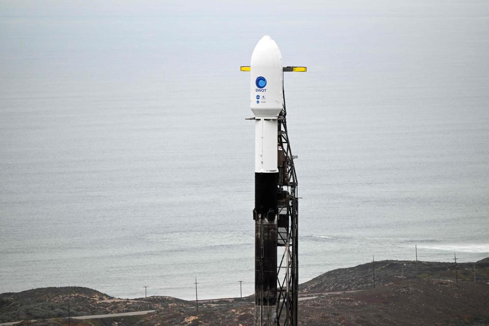 A SpaceX Falcon 9 rocket stands on a launch pad with the Surface Water and Ocean Topography (SWOT) satellite from NASA and France's space agency CNES at the Vandenberg Space Force Base in Lompoc, California on December 15, 2022.