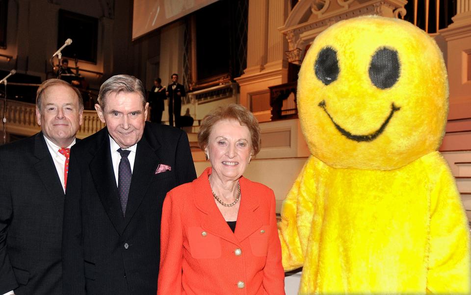 William D. Wallace, Executive Director of the Worcester Historical Museum, with Myles and Jean McDonough, recipients of the 2011 Harvey Ball Smile Award, stand with the Smiley at the Harvey Ball 2011 Smile Award Celebration at Mechanics Hall Oct. 6, 2011.