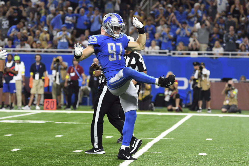 Detroit Lions defensive end Aidan Hutchinson (97) celebrates after sacking Washington Commanders quarterback Carson Wentz (11) during the first half of an NFL football game Sunday, Sept. 18, 2022, in Detroit. (AP Photo/Lon Horwedel)