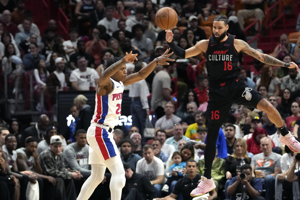 Detroit Pistons guard Marcus Sasser, left, passes the ball as Miami Heat forward Caleb Martin (16) defends during the first half of an NBA basketball game Tuesday, March 5, 2024, in Miami. (AP Photo/Lynne Sladky)