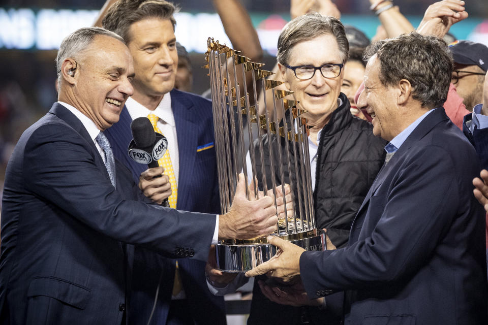 LOS ANGELES, CA - OCTOBER 28: Major League Baseball Commissioner Rob Manfred presents the World Series trophy to Boston Red Sox Principal Owner John Henry, Chairman Tom Werner, and President & CEO Sam Kennedy after winning the 2018 World Series in game five against the Los Angeles Dodgers on October 28, 2018 at Dodger Stadium in Los Angeles, California. (Photo by Billie Weiss/Boston Red Sox/Getty Images)