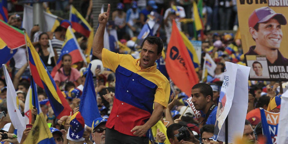 Opposition presidential candidate Henrique Capriles greets his supporters during a campaign rally in Caracas, Venezuela, Sunday, Sept. 30, 2012. Capriles is running against President Hugo Chavez in the country's Oct. 7 election. (AP Photo/Fernando Llano)