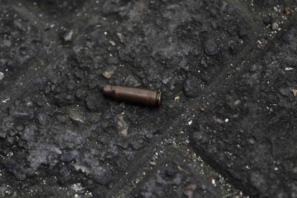 A bullet shell is seen at the site of Lekki toll gate in Lagos Friday, Oct. 23, 2020. Resentment lingered with the smell of charred tires Friday as Nigeria's streets were relatively calm after days of protests over police abuses, while authorities gave little acknowledgement to reports of the military killing at least 12 peaceful demonstrators earlier this week.(AP Photo/Sunday Alamba)