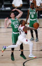 Portland Trail Blazers' Damian Lillard front goes up to shoot against Boston Celtics' Gordon Hayward during an NBA basketball game Sunday, Aug. 2, 2020, in Lake Buena Vista, Fla. (Mike Ehrmann/Pool Photo via AP)