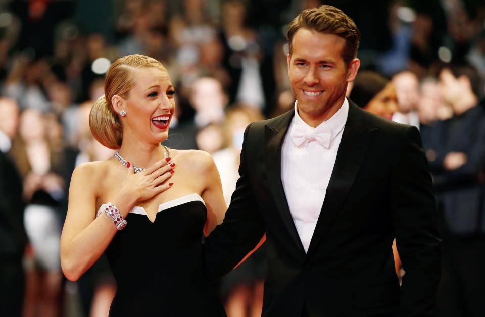 Blake Lively laughing with Ryan Reynolds at an event