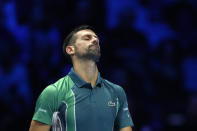 Serbia's Novak Djokovic reacts during the singles tennis match against Italy's Jannik Sinner, of the ATP World Tour Finals at the Pala Alpitour, in Turin, Italy, Tuesday, Nov. 14, 2023. (AP Photo/Antonio Calanni)