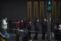 People wearing face masks to protect against the spread of the coronavirus line up for mass COVID-19 testing in a central district of Beijing, Friday, Jan. 22, 2021. Beijing has ordered fresh rounds of coronavirus testing for about 2 million people in the downtown area following new cases in the Chinese capital. (AP Photo/Mark Schiefelbein)