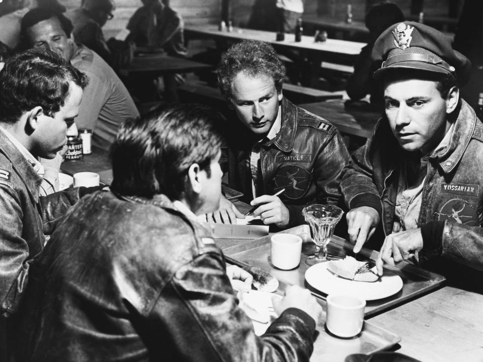 alan arkin and three other actors wearing military uniforms in a publicity photo from the film catch 22
