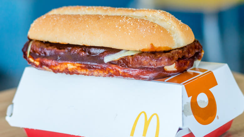 McRib posed atop container on table