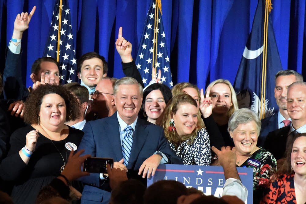 Supporters pose with U.S. Sen. Lindsey Graham, center, following his victory speech after winning another term in office on Tuesday, Nov. 3, 2020, in Columbia, S.C. (AP Photo/Meg Kinnard)