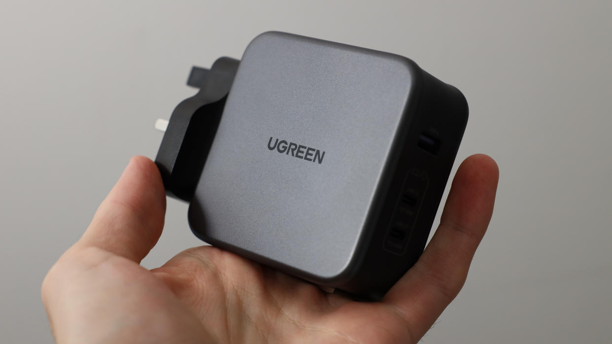  Ugreen Nexode 140W charger held in a hand. 