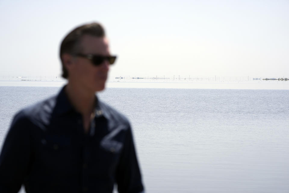 California Gov. Gavin Newsom stands along Tulare Lake during a tour of flooded zones Tuesday, April 25, 2023, in Corcoran, Calif. (AP Photo/Marcio Jose Sanchez, Pool)