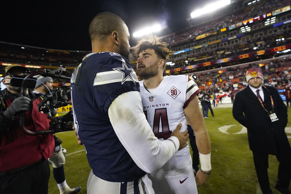 Washington Commanders quarterback Sam Howell (14) and Dallas Cowboys quarterback Dak Prescott (4) greet one another on the field at the end of an NFL football game, Sunday, Jan. 8, 2023, in Landover, Md. Washington won 26-6. (AP Photo/Alex Brandon)