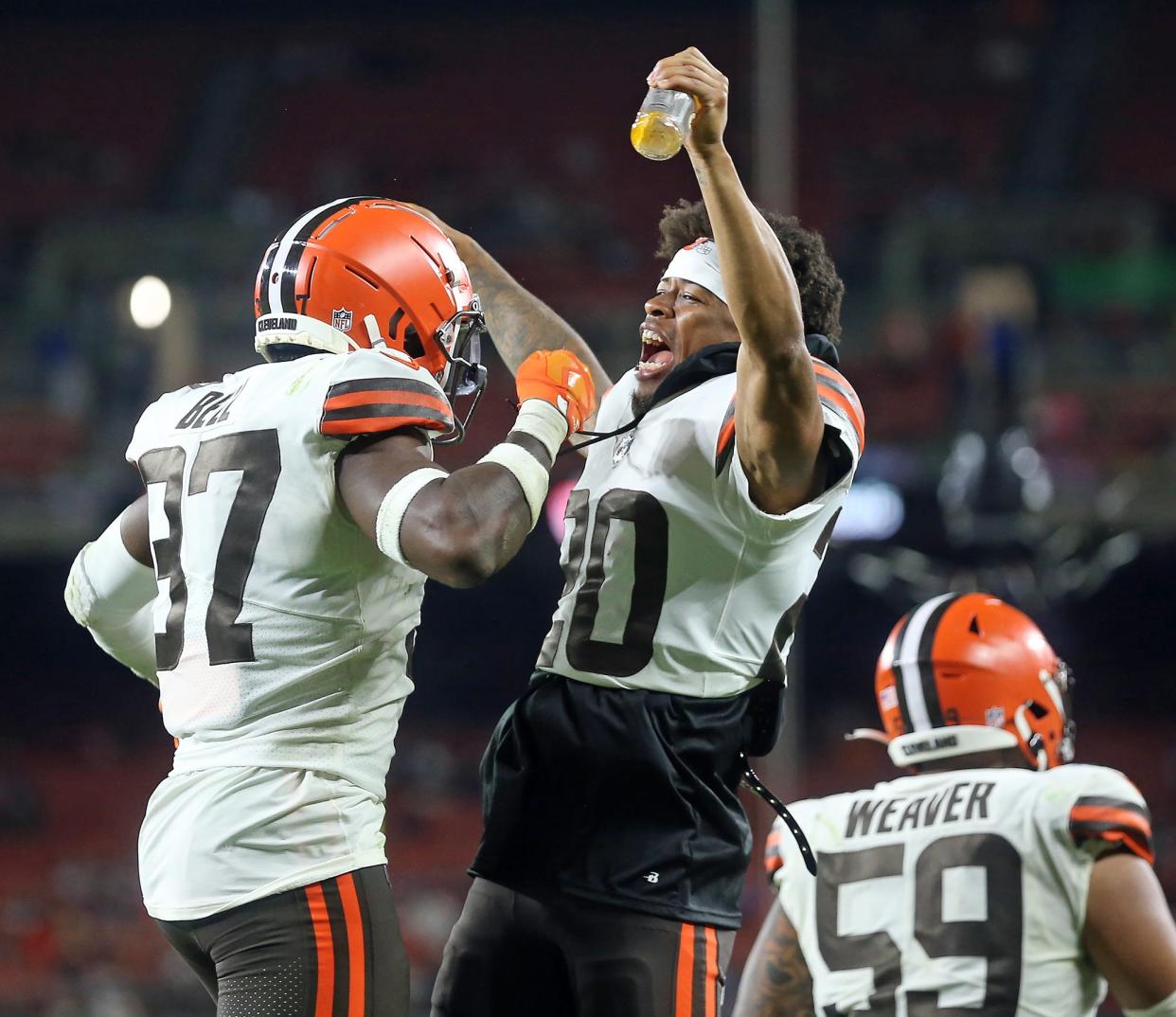 Browns cornerback Greg Newsome II (20) celebrates with safety D'Anthony Bell (37) after a fumble recovery during the second half of a preseason game, Aug. 27, 2022, in Cleveland.