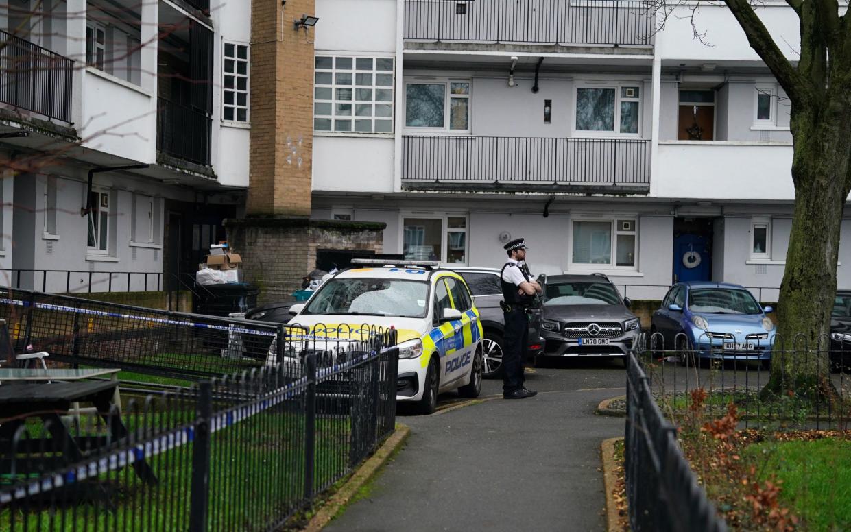 Police outside Spenlow House in Bermondsey where a woman was stabbed to death