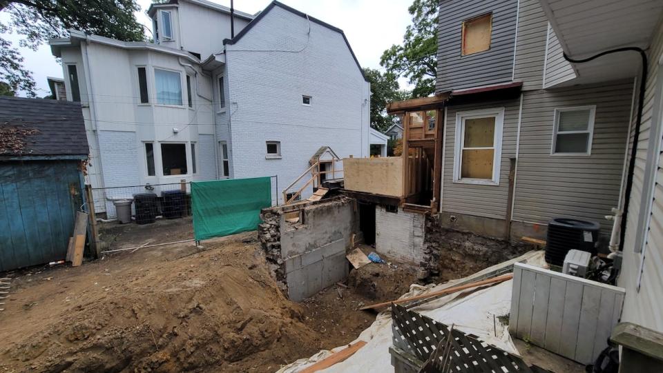 The Shifrins say their backyard was excavated without their permission. The Buttons say their neighbours agreed to the excavation when they signed a party wall agreement.