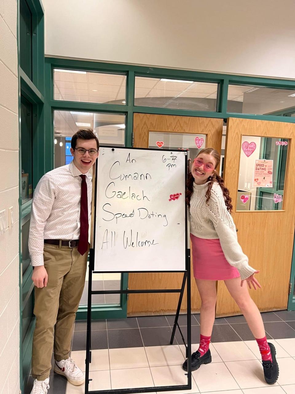 Ó Treasaigh said the Irish Society at St. Thomas University was revived this year. Seen here, two students pose with a sign for the society's speed dating event.