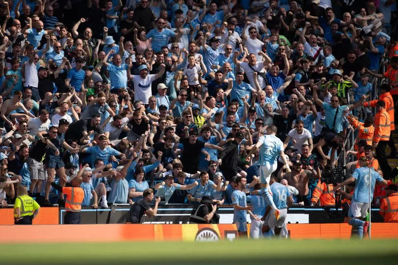 Manchester City fans celebrate a goal