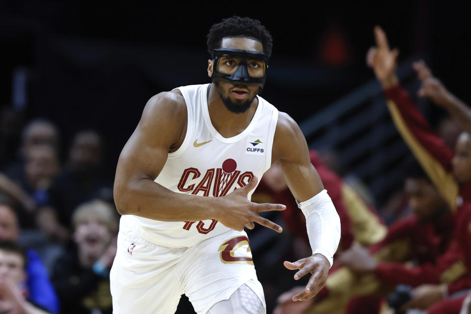 Cleveland Cavaliers guard Donovan Mitchell reacts after making a 3-point basket against the Philadelphia 76ers during the first half of an NBA basketball game Friday, March 29, 2024, in Cleveland. (AP Photo/Ron Schwane)