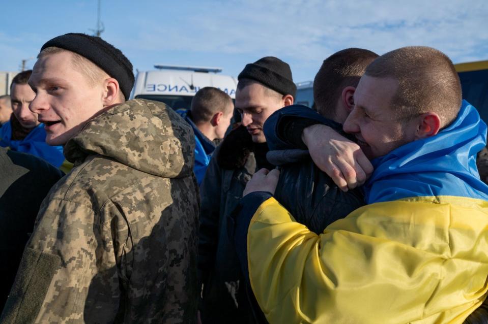 Ukrainian prisoners of war (POWs) react after a swap, amid Russia’s attack on Ukraine, at an unknown location in Ukraine (via REUTERS)