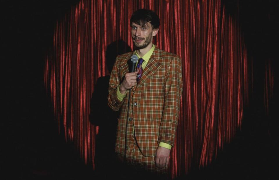 Richard Gadd as Donny Dunn in a plaid suit on stage