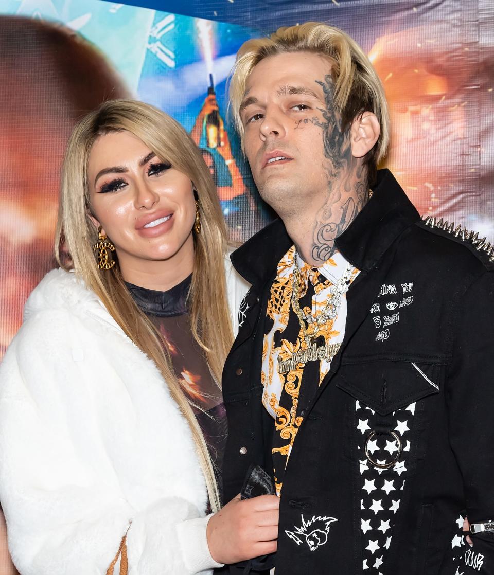 Aaron Carter and Melanie Martin pose together on the red carpet in 2021.