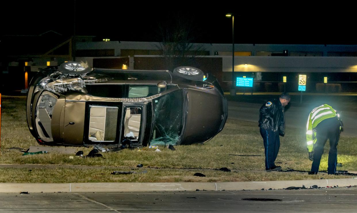 Peoria police officers inspect wreckage at the scene of a fatal crash Wednesday, Nov. 30, 2022, at the intersection of North Orange Prairie Road and West American Prairie Drive in Peoria.