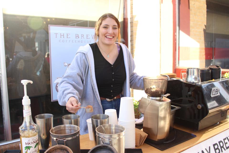 Broadway Brew barista Monet Parker prepares a beverage at the Downtown Plainview Streetscape Celebration on Friday, April 8, 2022.