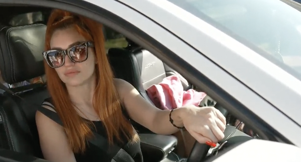 A young mother is pictured being interviewed from her car. She thought distributing fines to non-residents is 