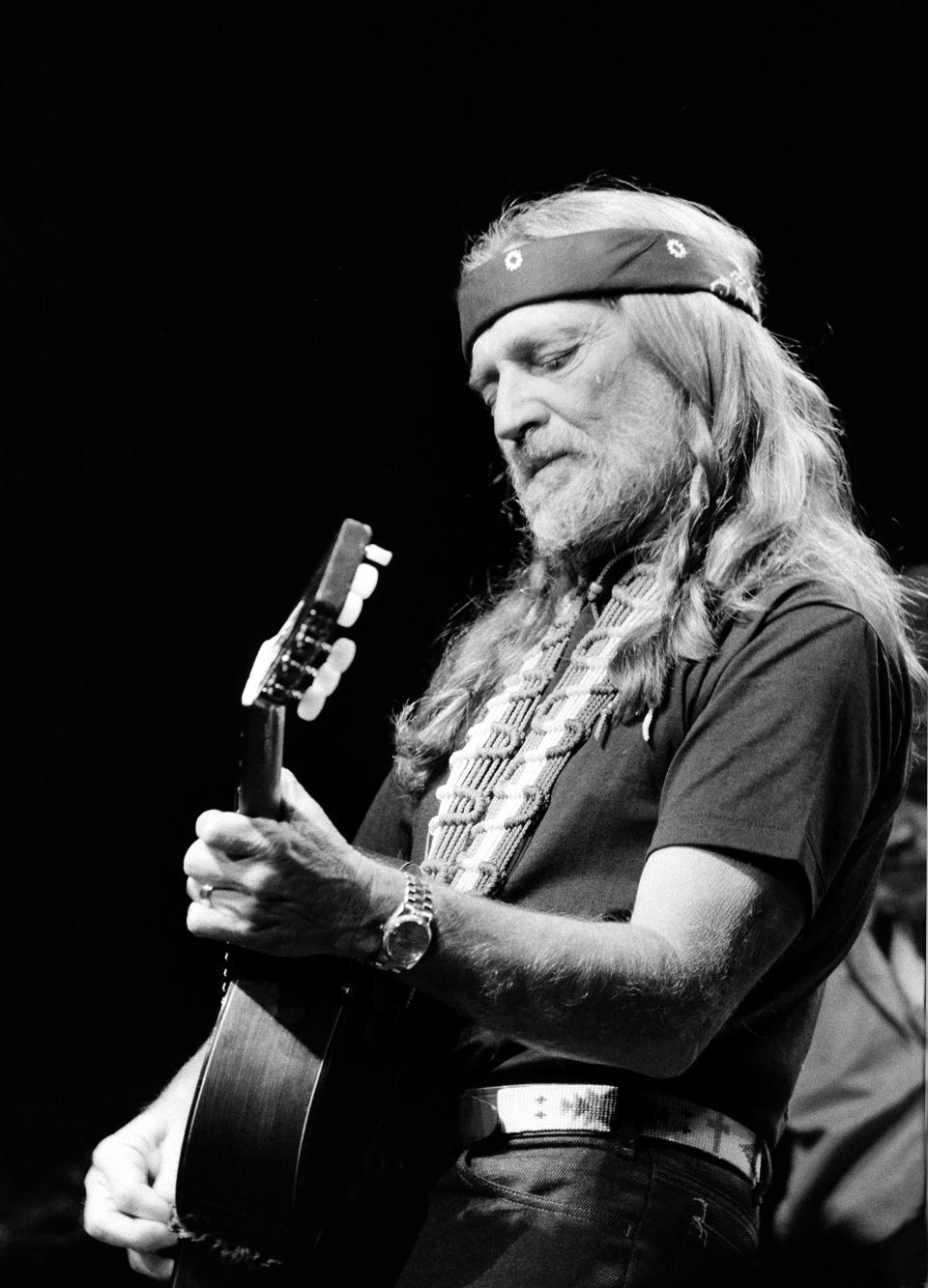 FILE - Willie Nelson performs at New York's Radio City Music Hall Thursday night in the first of six sold-out concerts, May 25, 1984. The country legend's new book, “Energy Follows Thought,” gives the stories behind his most famous songs. (AP Photo/Richard Drew, File)
