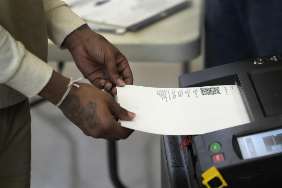 An inmate at the Cook County, Ill., jail casts his ballot after voting in the local election at the jail's Division 11 Chapel on Saturday, Feb. 18, 2023, in Chicago. (AP Photo/Charles Rex Arbogast)