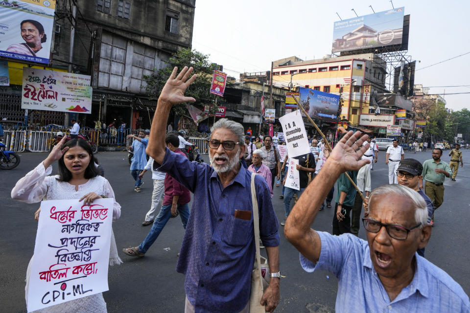 Activists and supporter of Communist Party of India (Marxist-Leninist) block a road during a protest against the Citizenship Amendment Act (CAA), in Kolkata, India, Tuesday, March 12, 2024. India has implemented a controversial citizenship law that has been widely criticized for excluding Muslims, a minority community whose concerns have heightened under Prime Minister Narendra Modi's Hindu nationalist government. The act provides a fast track to naturalization for Hindus, Parsis, Sikhs, Buddhists, Jains and Christians who fled to Hindu-majority India from Afghanistan, Bangladesh and Pakistan before Dec. 31, 2014. (AP Photo/Bikas Das)