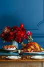 <p>With this striking arrangement of dahlias, roses and ranunculus, the cranberry sauce won't be the most colorful part of your Thanksgiving spread. Place all of them in a colored ceramic vase for added dimension.</p>