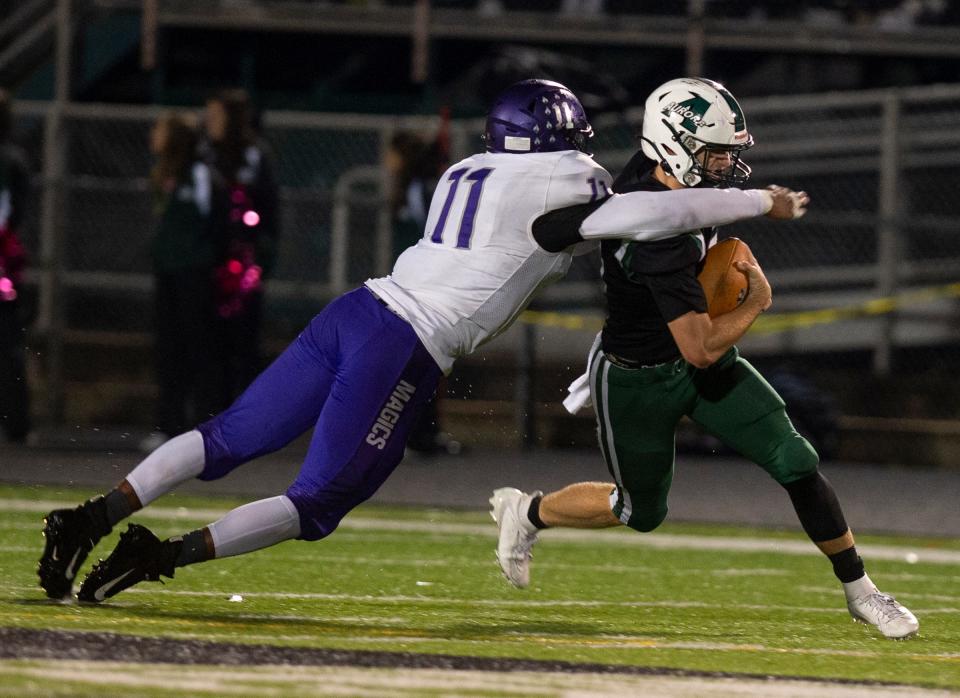 Barberton's Roosevelt Andrews tackles Aurora quarterback Matt Geier during the 2022 season.