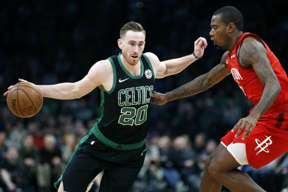 Boston Celtics' Gordon Hayward (20) drives past Houston Rockets' Gary Clark (6) during the first half of an NBA basketball game in Boston, Sunday, March 3, 2019. (AP Photo/Michael Dwyer)