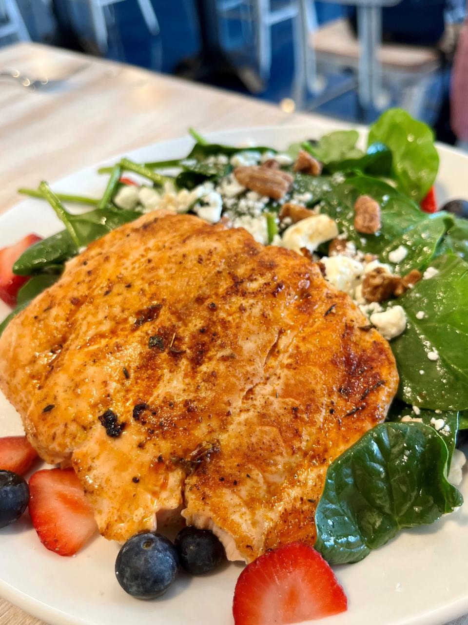 The strawberry zinfandel salad, pictured with grilled salmon added, is on the lunch and dinner menu at Wickies Lighthouse.
