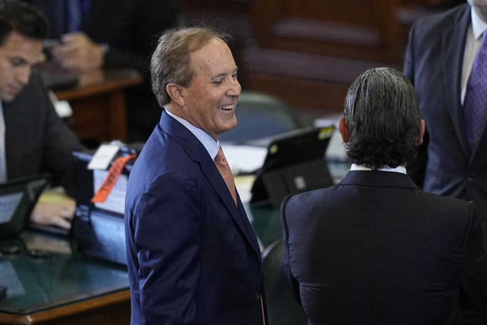 Texas state Attorney General Ken Paxton, left, talks with his attorneys before his impeachment trial for Texas Attorney General Ken Paxton in the Senate Chamber at the Texas Capitol, Tuesday, Sept. 5, 2023, in Austin, Texas. (AP Photo/Eric Gay)