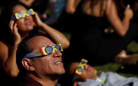 People watch the solar eclipse on the lawn of Griffith Observatory in Los Angeles, California, U.S., August 21, 2017. Location coordinates for this image are 34°7'9"N 118°18'1"W. REUTERS/Mario Anzuoni