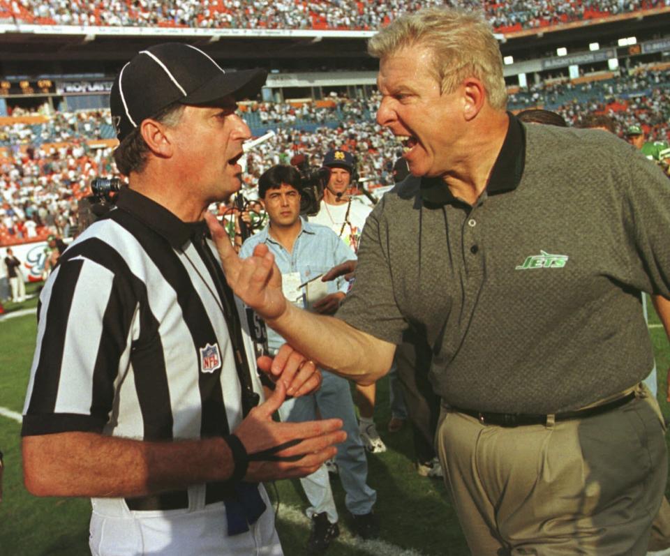 FILE - New York Jets head coach Bill Parcells complains to side judge Mike Pereira at the conclusion of a game against the Miami Dolphins at Pro Player Stadium in Miami Sunday, Nov. 9, 1997. Parcells was arguing a call late in the fourth quarter that was ruled as an incomplete pass to wide receiver Wayne Chrebet. The Dolphins defeated the Jets 24-17. (AP Photo/Hans Deryk, File)