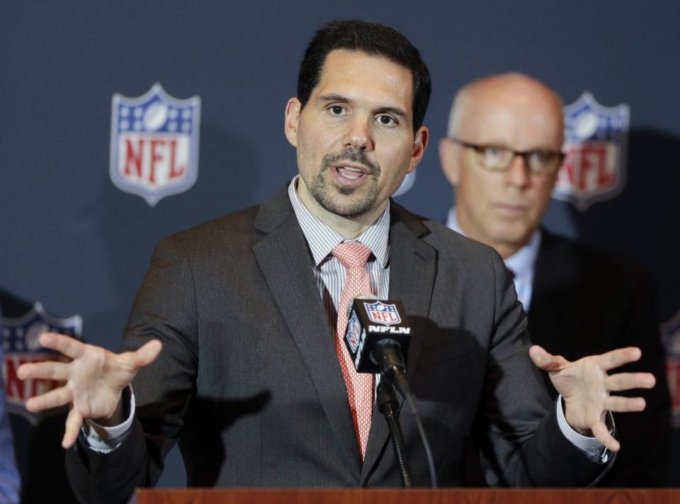 NFL vice president of officiating Dean Blandino speaks during a news conference, while Atlanta Falcons President, CEO and NFL competition committee member Rich McKay, back right, listens, at the NFL football annual meeting in Orlando, Fla., Monday, March 24, 2014. (AP Photo/John Raoux)