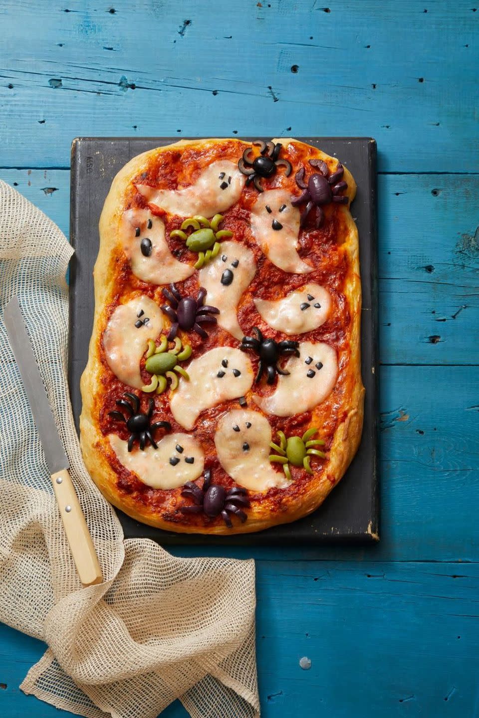 <p>Normally bugs on your food is a turn off — but not when they're made of olives. And if olives aren't your thing, you can still enjoy a cheesy, ghostly pizza.</p><p>Get the recipe from <a href="https://www.womansday.com/food-recipes/a33564112/ghostly-pizza-recipe/" rel="nofollow noopener" target="_blank" data-ylk="slk:Woman's Day;elm:context_link;itc:0;sec:content-canvas" class="link ">Woman's Day</a>.</p>