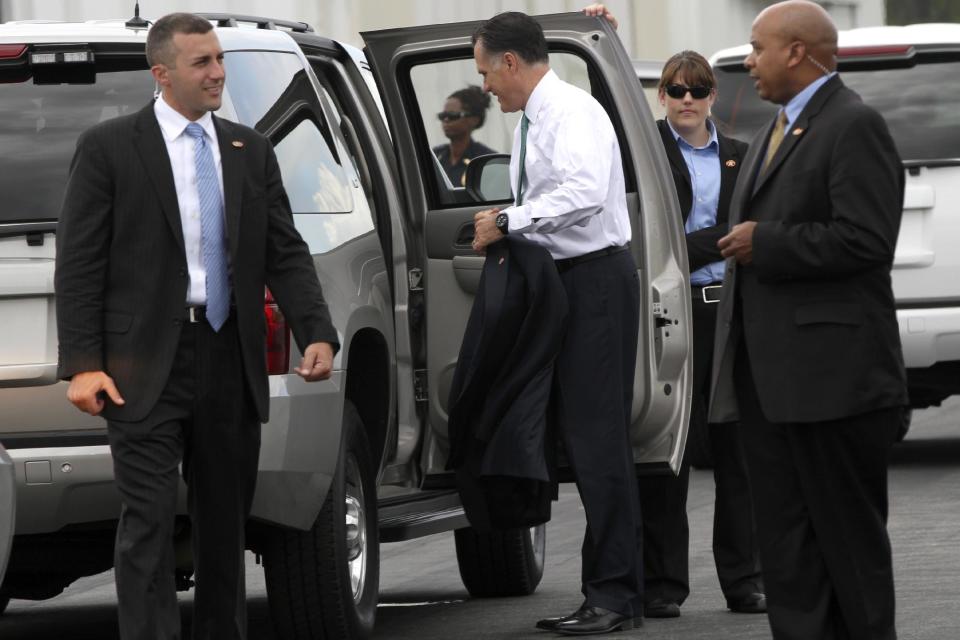 Republican presidential candidate, former Massachusetts Gov. Mitt Romney is surrounded by members of the Secret Service as he arrives in Jacksonville, Fla., Thursday, May 17, 2012. (AP Photo/Mary Altaffer)