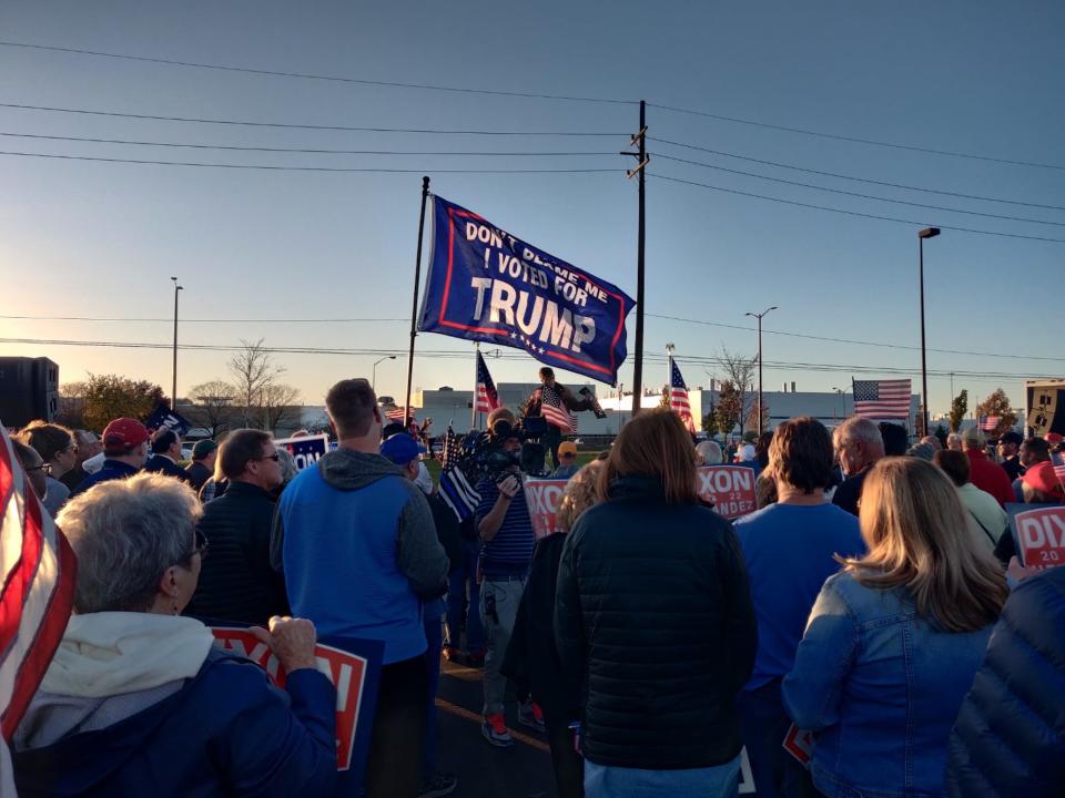 A rally goer holds aloft a Trump flag during a campaign stop by GOP gubernatorial hopeful Tudor Dixon in Sterling Heights, Michigan on November 6, 2022.