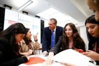 Britain's Secretary of State for International Trade Liam Fox visits students taking part in a mock trade negotiation at Harris Westminster Sixth Form college in central London