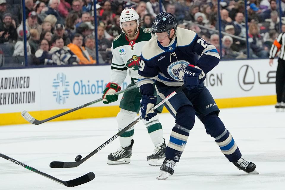 Feb 23, 2023; Columbus, Ohio, USA;  Columbus Blue Jackets left wing Patrik Laine (29) moves the puck past Minnesota Wild right wing Ryan Hartman (38) during the first period of the NHL hockey game at Nationwide Arena. Mandatory Credit: Adam Cairns-The Columbus Dispatch