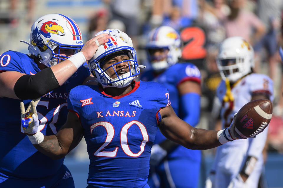 Kansas running back Daniel Hishaw Jr. (20) celebrates with teammate offensive lineman Mike Novitsky (50) after scoring a touchdown against Iowa State during the first half of an NCAA college football game, Saturday, Oct. 1, 2022, in Lawrence, Kan. (AP Photo/Reed Hoffmann)