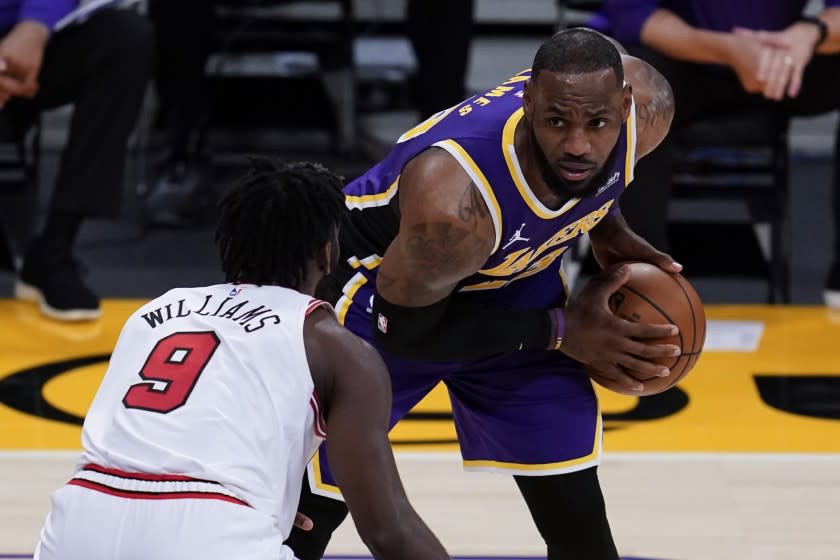 Los Angeles Lakers forward LeBron James, right, looks past Chicago Bulls forward Patrick Williams.